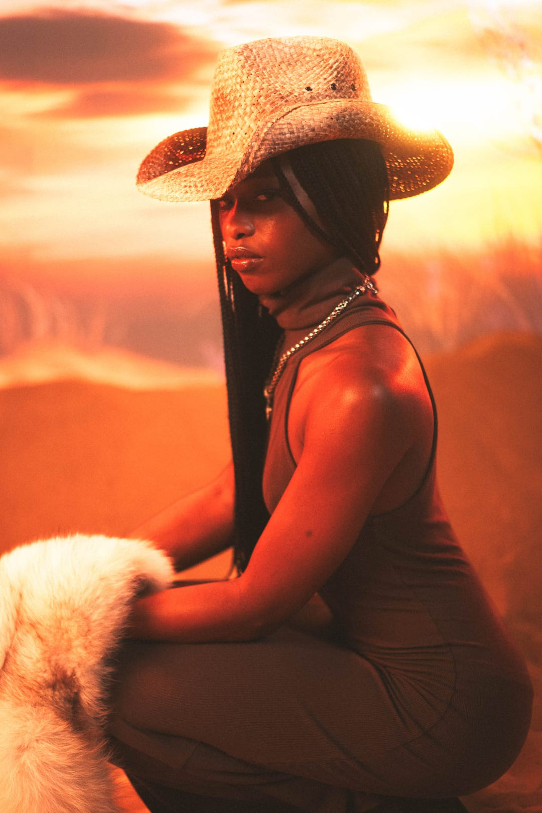 Model in cowboy hat and fur with golden sunset lighting at Denim and Archives Miami editorial shoot