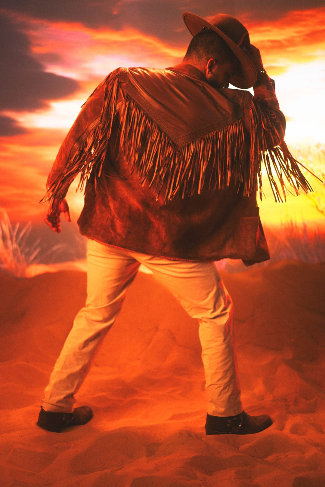 Editorial fashion shot with warm golden lighting featuring vintage suede and denim styling