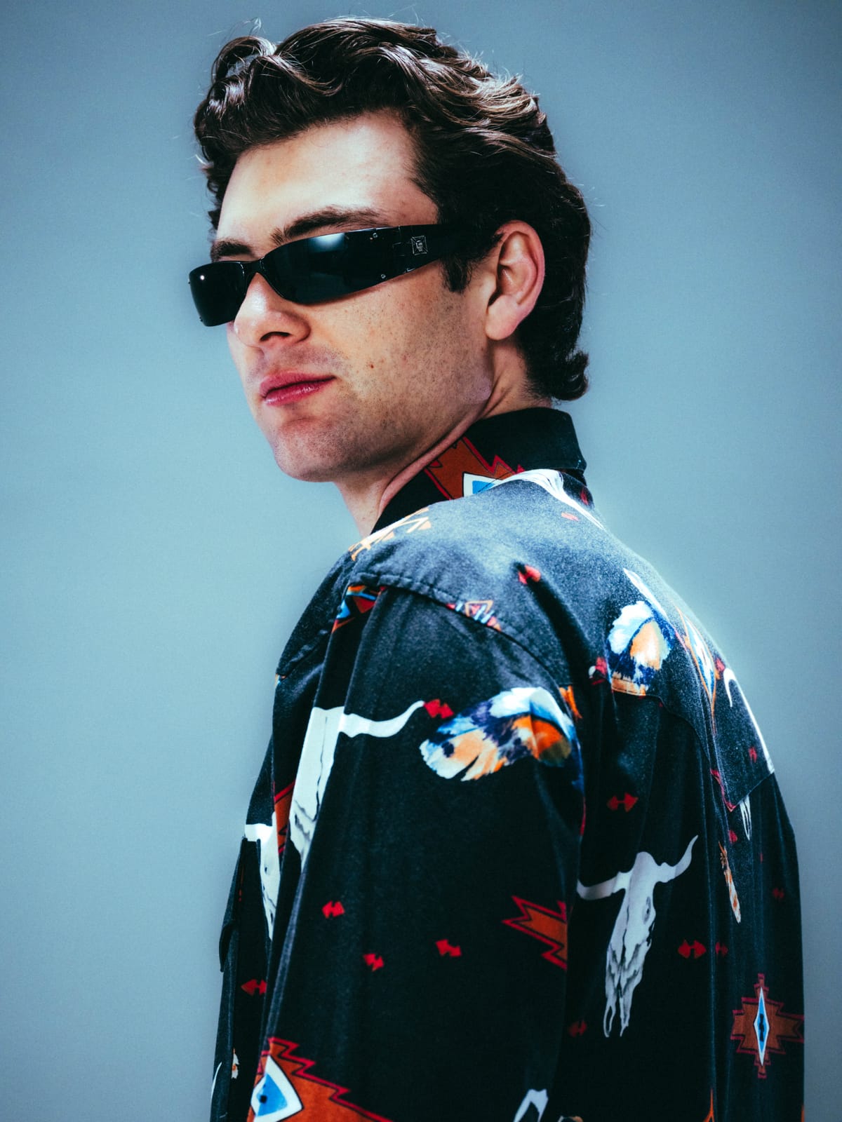 Close-up detail of vintage western print shirt with bull skull and eagle motifs showing fabric quality