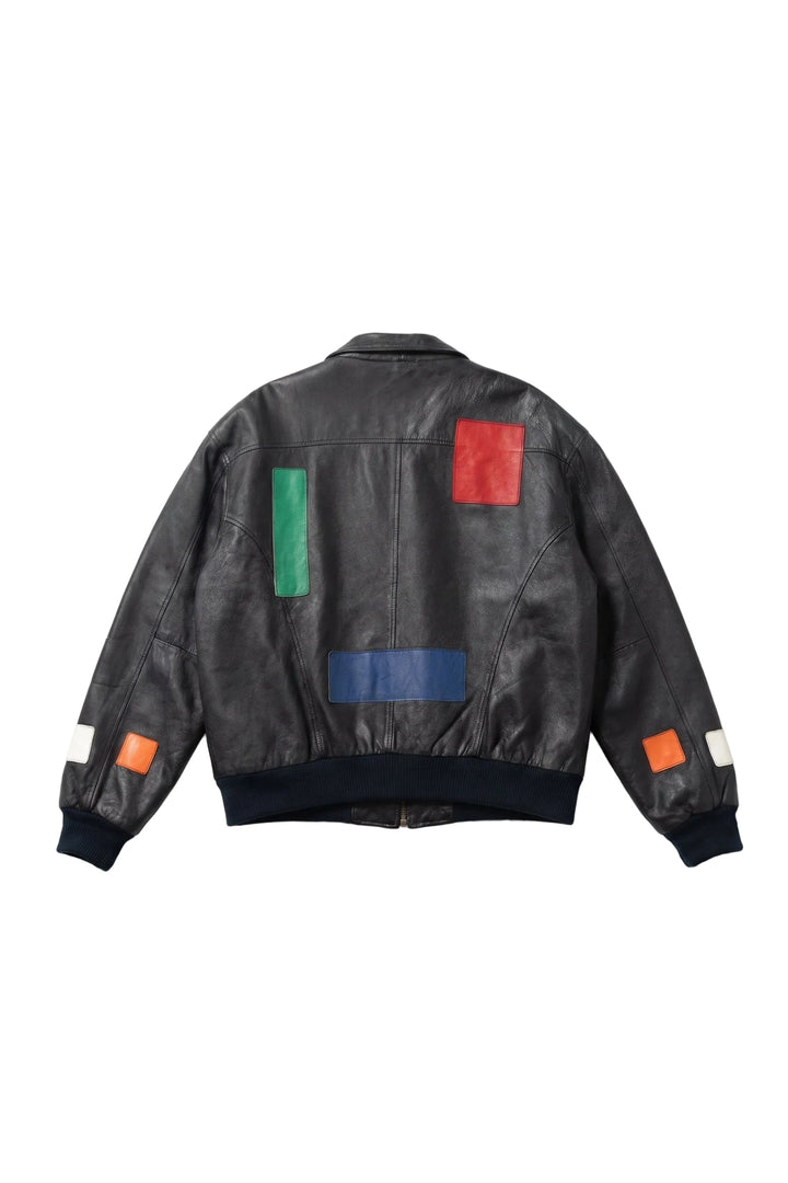 Black leather jacket with colorful square patches on a white background