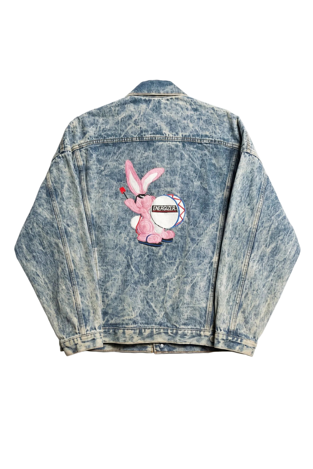 Denim jacket with a pink cartoon character patch on a white background
