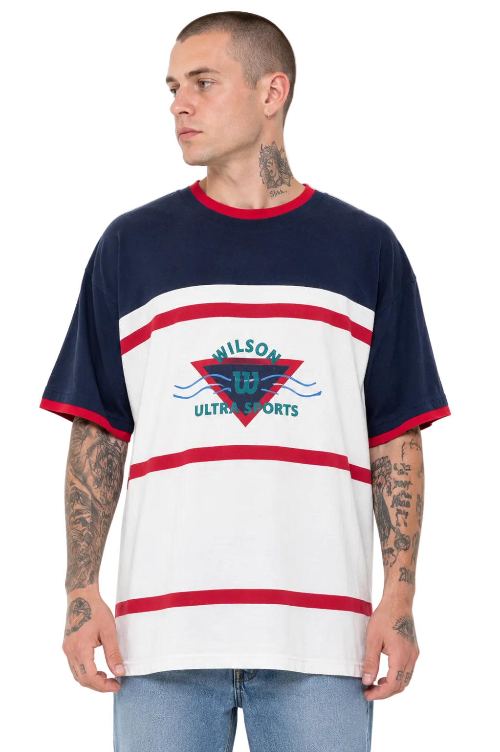 A man wearing a Wilson Ultra Sports short-sleeve t-shirt with navy blue, white, and red horizontal stripes, featuring a red and blue geometric logo on the chest.