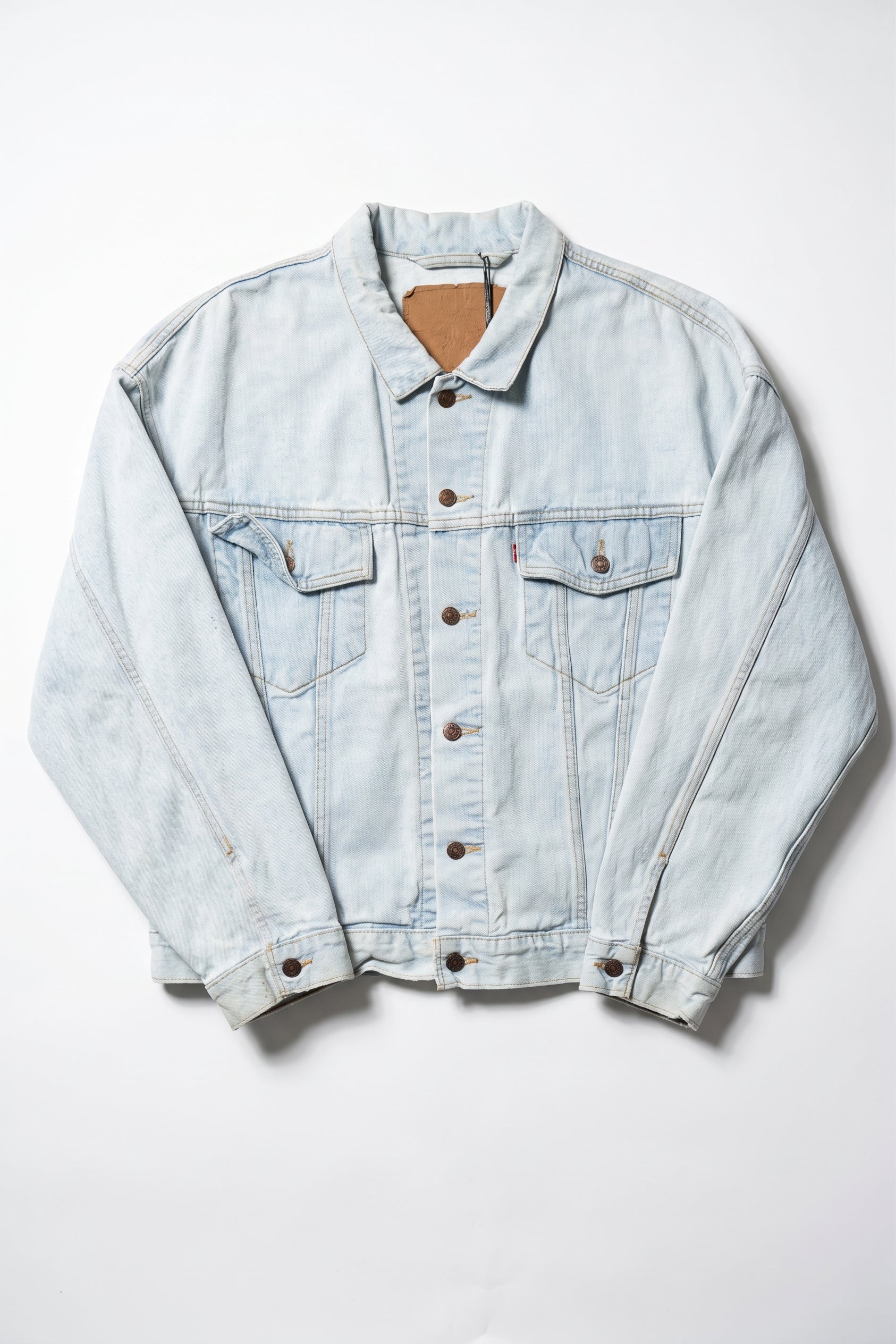 Light blue denim jacket on a white background