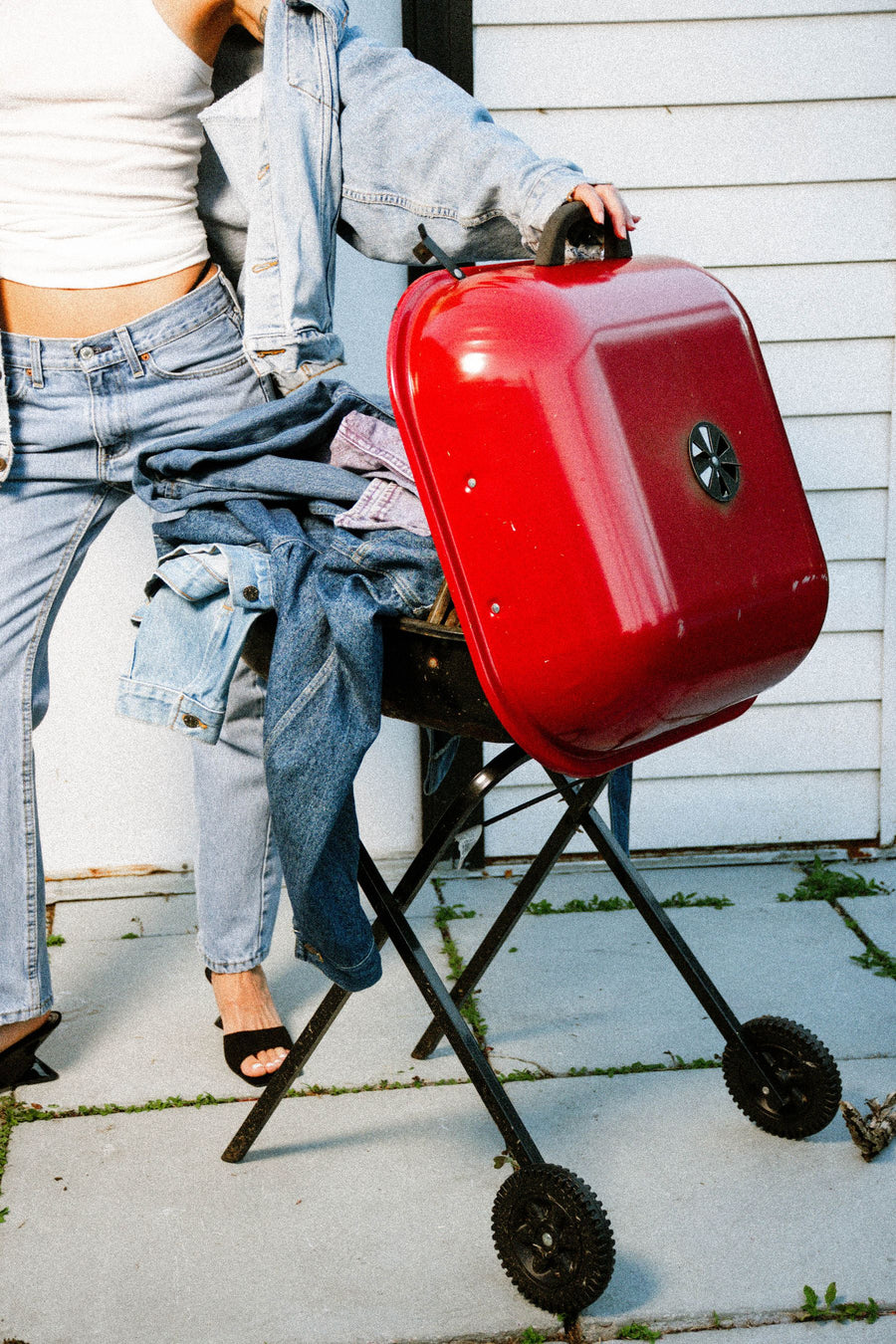 A red grill piled with vintage denim jackets