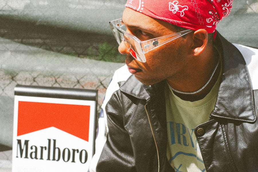 Clear shield glasses and a red bandana, Marlboro sign behind